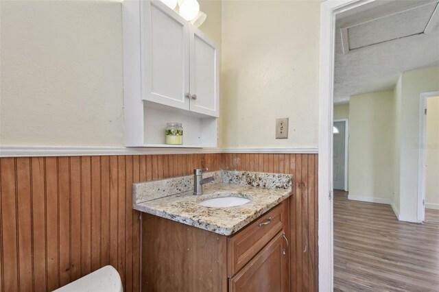 1810 77th Ave N, Saint Petersburg, FL 33702 - bathroom with wood finished floors, a wainscoted wall, vanity, and wood walls