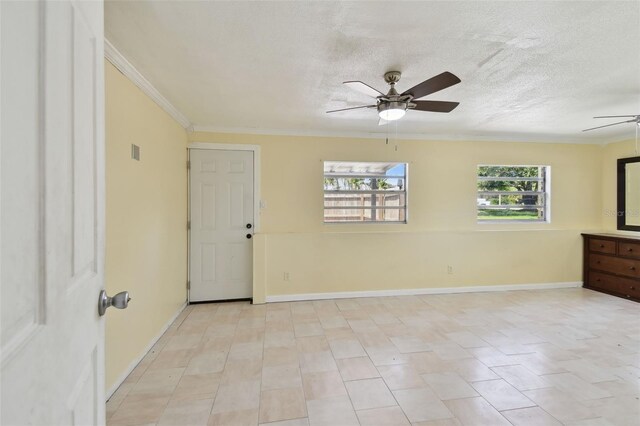 1810 77th Ave N, Saint Petersburg, FL 33702 - spare room with ceiling fan, ornamental molding, a textured ceiling, and baseboards