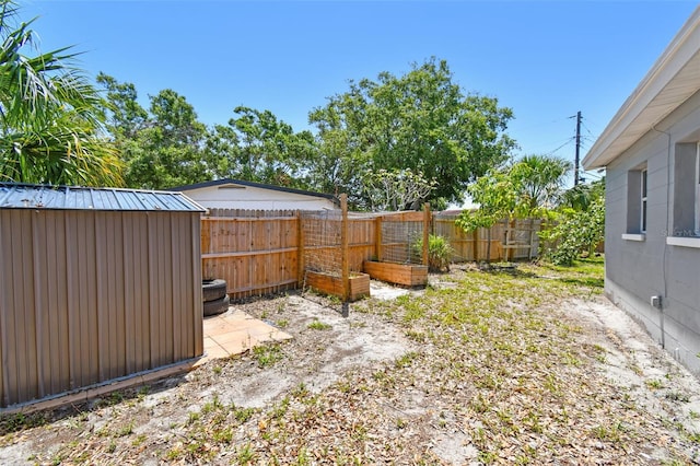 1810 77th Ave N, Saint Petersburg, FL 33702 - fenced backyard with a storage unit and an outbuilding