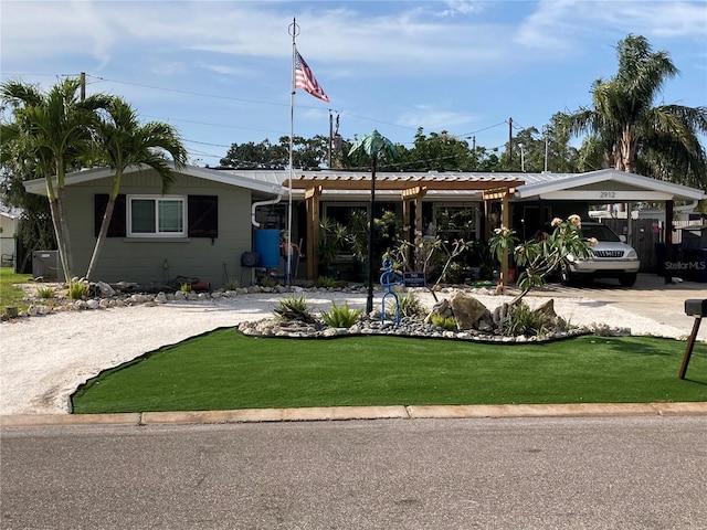 2912 Case Ave, Bradenton, FL 34207 - view of front of home featuring a front yard, a carport, and metal roof
