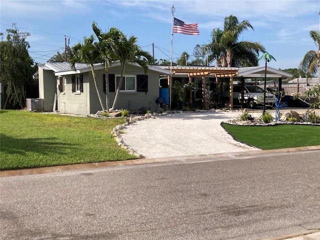 2912 Case Ave, Bradenton, FL 34207 - ranch-style home with gravel driveway, a front lawn, central air condition unit, and a carport