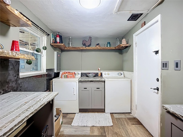 2912 Case Ave, Bradenton, FL 34207 - washroom featuring cabinet space, light wood finished floors, and washer and clothes dryer