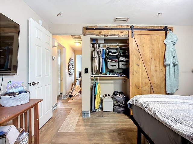 2912 Case Ave, Bradenton, FL 34207 - bedroom featuring wood finished floors and a barn door