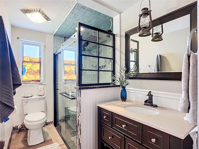 2912 Case Ave, Bradenton, FL 34207 - bathroom with vanity, a shower stall, wood finished floors, and a wainscoted wall
