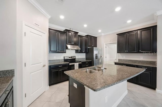 kitchen featuring appliances with stainless steel finishes, under cabinet range hood, a sink, crown molding, and dark stone counters