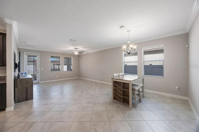 unfurnished dining area featuring ornamental molding, a ceiling fan, a chandelier, light tile patterned floors, and baseboards