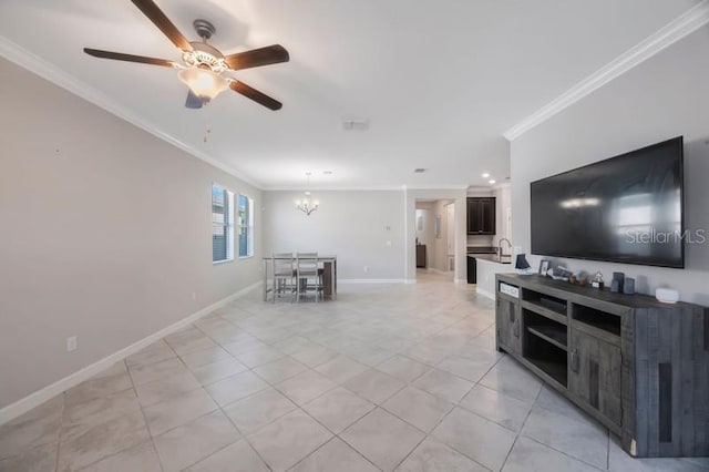 living area featuring ornamental molding, ceiling fan, a chandelier, light tile patterned floors, and baseboards
