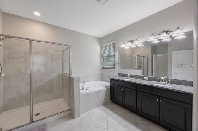 bathroom featuring a garden tub, a shower stall, tile patterned flooring, and double vanity