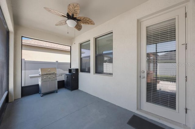 view of patio featuring ceiling fan, area for grilling, and fence