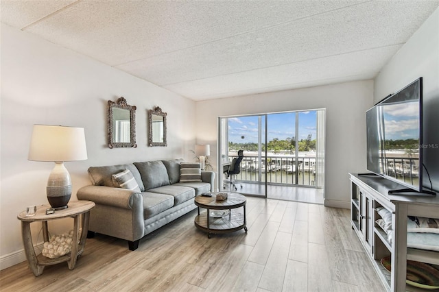 1 Boca Ciega Point Blvd Unit 310, Saint Petersburg, FL 33708 - living area with wood finished floors, a textured ceiling, and baseboards