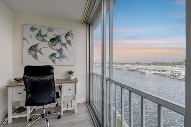 1 Boca Ciega Point Blvd Unit 310, Saint Petersburg, FL 33708 - home office featuring a water view, light wood-style floors, and baseboards