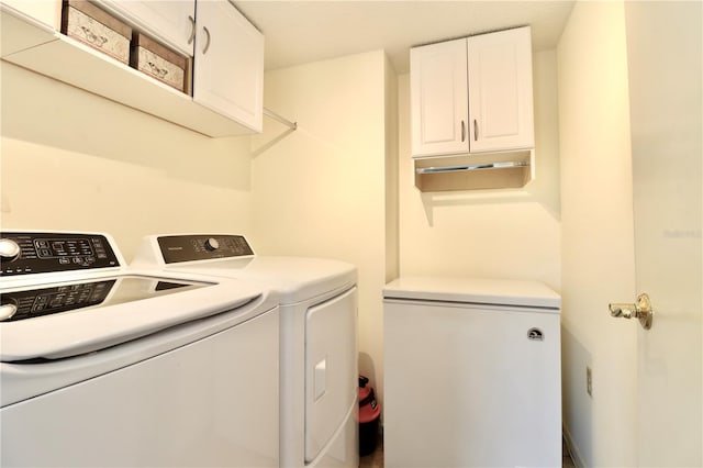 laundry area with washer and dryer and cabinet space