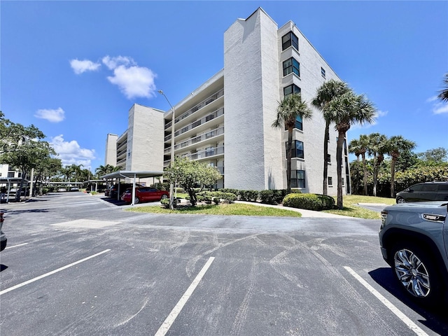view of building exterior featuring uncovered parking