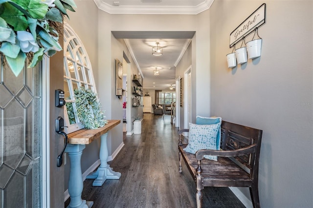entryway featuring crown molding, wood finished floors, and baseboards