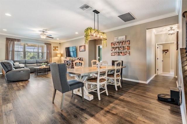 dining space featuring dark wood-style flooring, ceiling fan, baseboards, crown molding, and recessed lighting