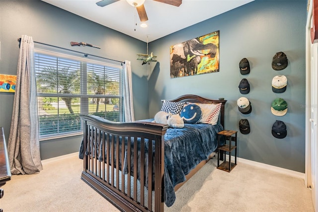 carpeted bedroom with baseboards and ceiling fan