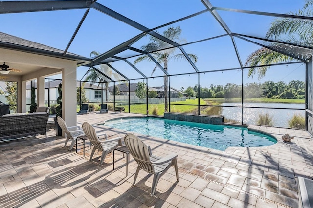swimming pool with a water view, a patio area, ceiling fan, and a lanai