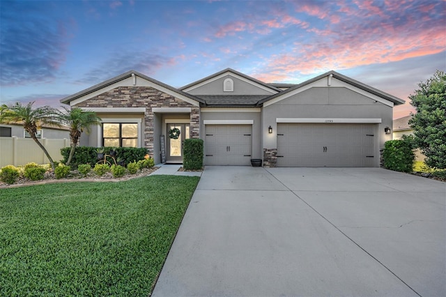 ranch-style home with stone siding, concrete driveway, an attached garage, and stucco siding