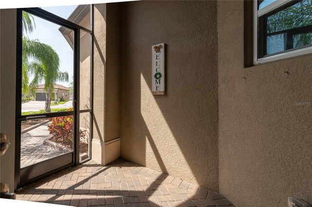 4888 Sevilla Shores Dr, Wimauma, FL 33598 - doorway to outside featuring a textured wall