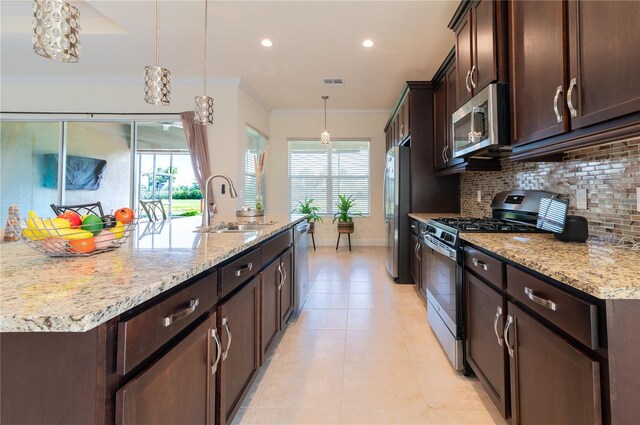 4888 Sevilla Shores Dr, Wimauma, FL 33598 - kitchen with stainless steel appliances, backsplash, dark brown cabinetry, a sink, and recessed lighting