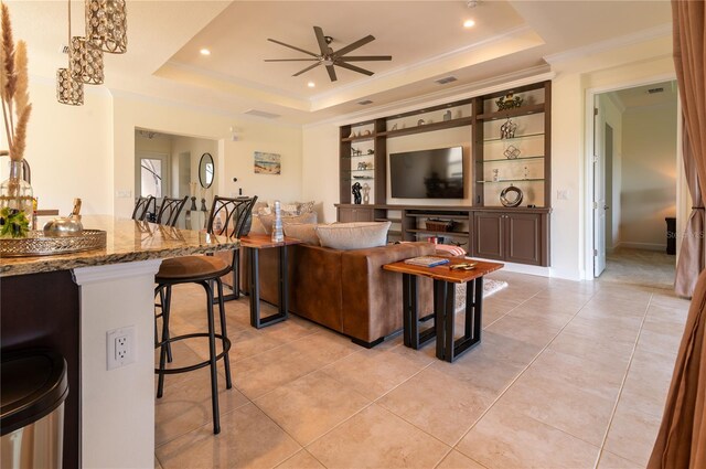 4888 Sevilla Shores Dr, Wimauma, FL 33598 - living room featuring a tray ceiling, ceiling fan, recessed lighting, light tile patterned flooring, and crown molding