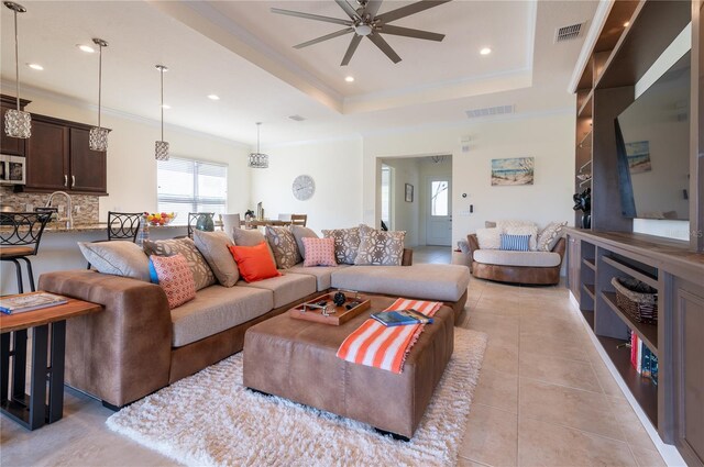 4888 Sevilla Shores Dr, Wimauma, FL 33598 - living room featuring ceiling fan, crown molding, light tile patterned floors, a tray ceiling, and recessed lighting