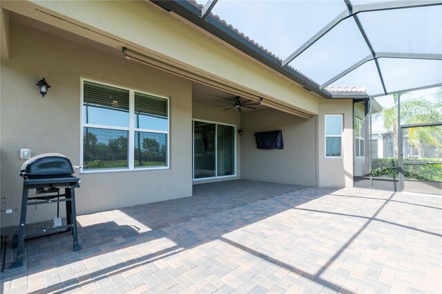 4888 Sevilla Shores Dr, Wimauma, FL 33598 - view of patio featuring ceiling fan, glass enclosure, and area for grilling