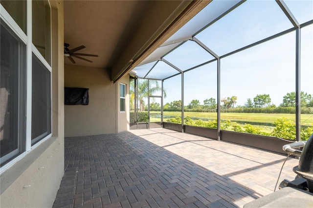 4888 Sevilla Shores Dr, Wimauma, FL 33598 - unfurnished sunroom with a ceiling fan