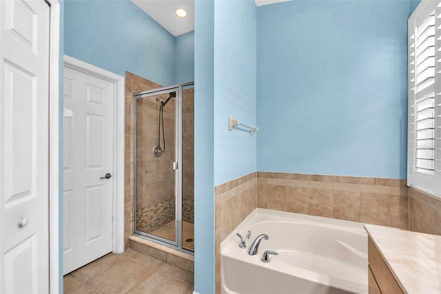 11808 Holly Crest Ln, Riverview, FL 33569 - bathroom featuring a bath, a stall shower, tile patterned floors, and healthy amount of natural light