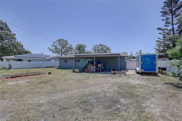rear view of house with an outbuilding and a shed