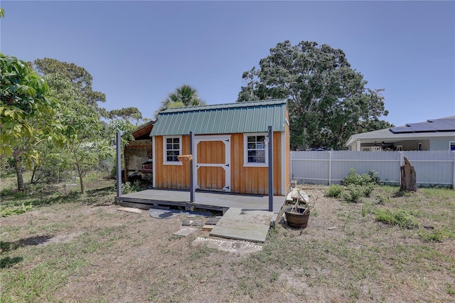 view of shed featuring fence