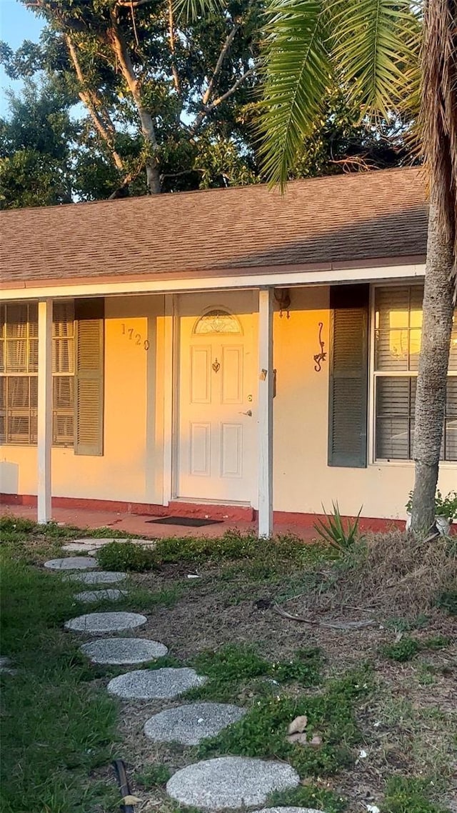 entrance to property featuring stucco siding