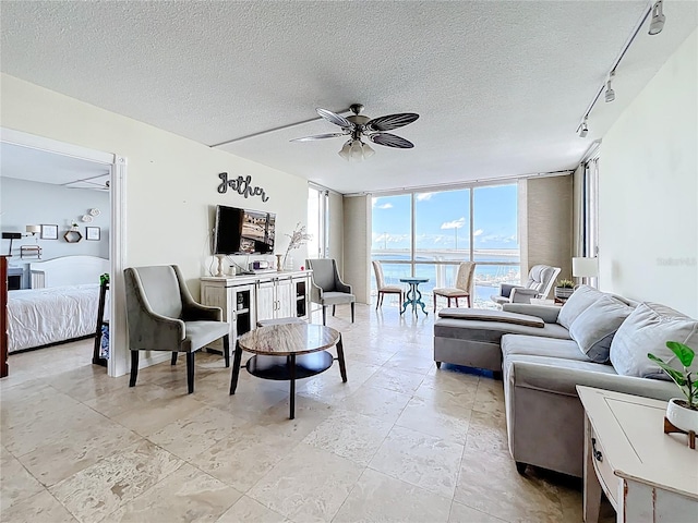 100 Pierce St Unit 910, Clearwater, FL 33756 - living area with ceiling fan, a textured ceiling, rail lighting, and floor to ceiling windows