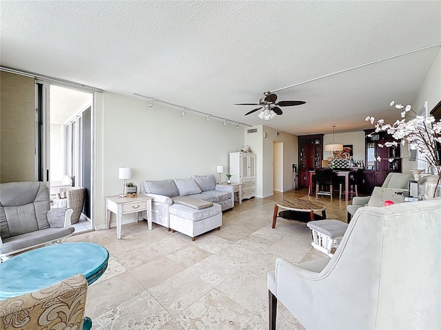100 Pierce St Unit 910, Clearwater, FL 33756 - living area featuring a ceiling fan and a textured ceiling