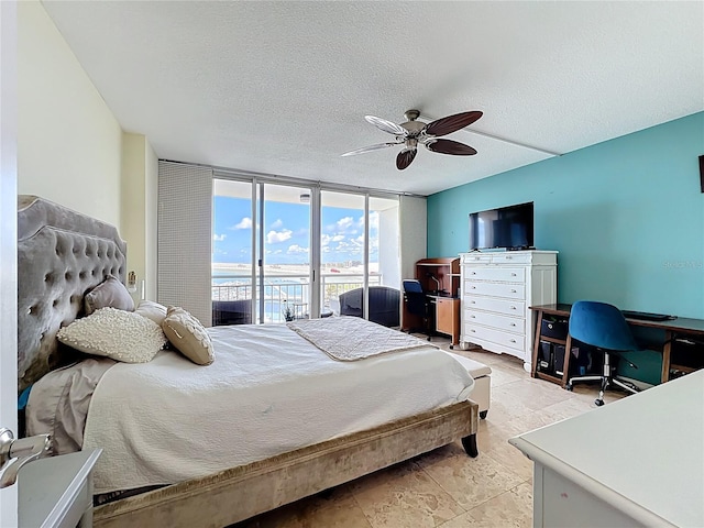 100 Pierce St Unit 910, Clearwater, FL 33756 - bedroom with expansive windows, a textured ceiling, a ceiling fan, and an office area