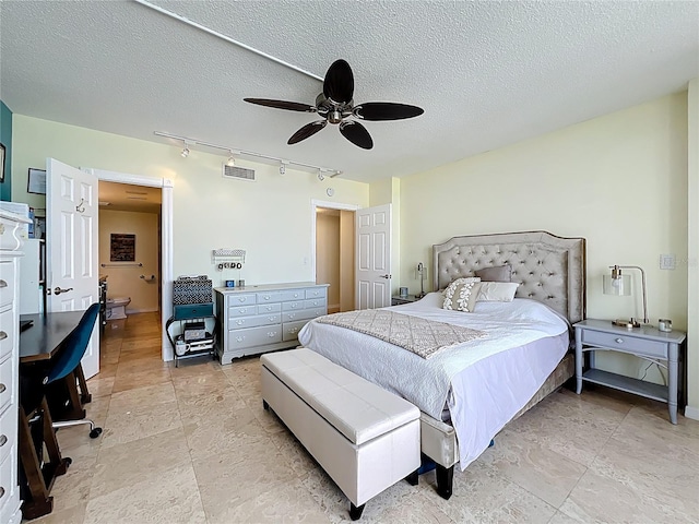 100 Pierce St Unit 910, Clearwater, FL 33756 - bedroom with rail lighting, a ceiling fan, and a textured ceiling