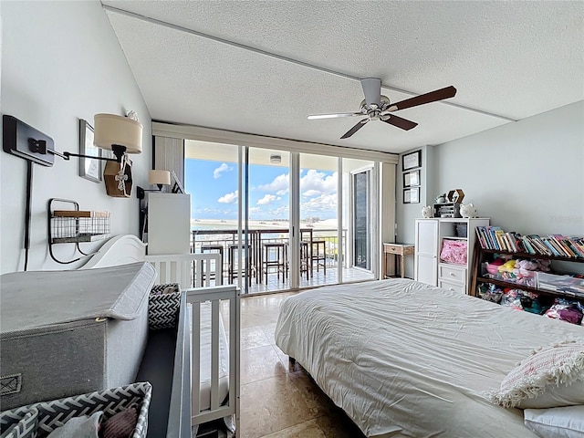 100 Pierce St Unit 910, Clearwater, FL 33756 - bedroom with access to exterior, a wall of windows, a textured ceiling, and a ceiling fan