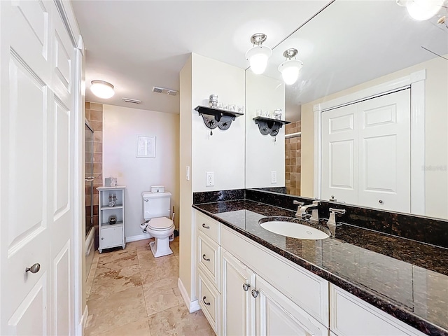 100 Pierce St Unit 910, Clearwater, FL 33756 - bathroom featuring toilet, a tile shower, vanity, and baseboards