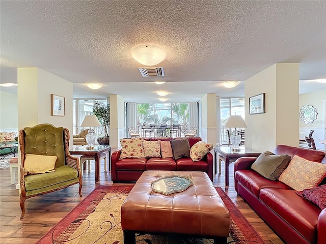100 Pierce St Unit 910, Clearwater, FL 33756 - living area featuring hardwood / wood-style flooring, healthy amount of natural light, and a textured ceiling