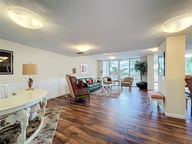100 Pierce St Unit 910, Clearwater, FL 33756 - living area featuring a textured ceiling, dark wood finished floors, and a wainscoted wall