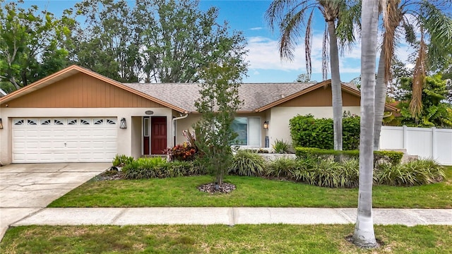 3093 Hillside Ln, Safety Harbor, FL 34695 - view of front of house with an attached garage, driveway, a shingled roof, and stucco siding