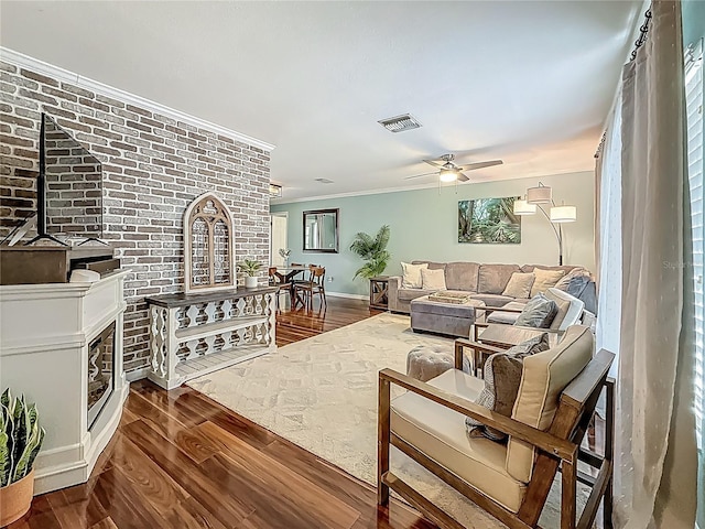 3093 Hillside Ln, Safety Harbor, FL 34695 - living room featuring dark wood-style flooring, crown molding, ceiling fan, baseboards, and plenty of natural light