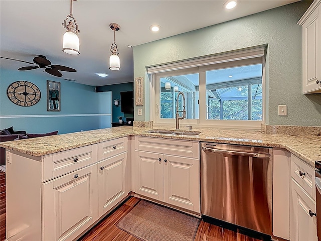 3093 Hillside Ln, Safety Harbor, FL 34695 - kitchen with stainless steel dishwasher, a sink, white cabinets, ceiling fan, and pendant lighting