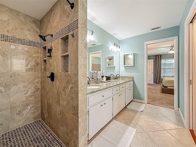 3093 Hillside Ln, Safety Harbor, FL 34695 - ensuite bathroom with double vanity, tiled shower, and tile patterned flooring