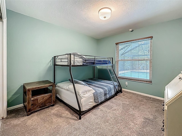 3093 Hillside Ln, Safety Harbor, FL 34695 - bedroom featuring light colored carpet, a textured ceiling, and baseboards