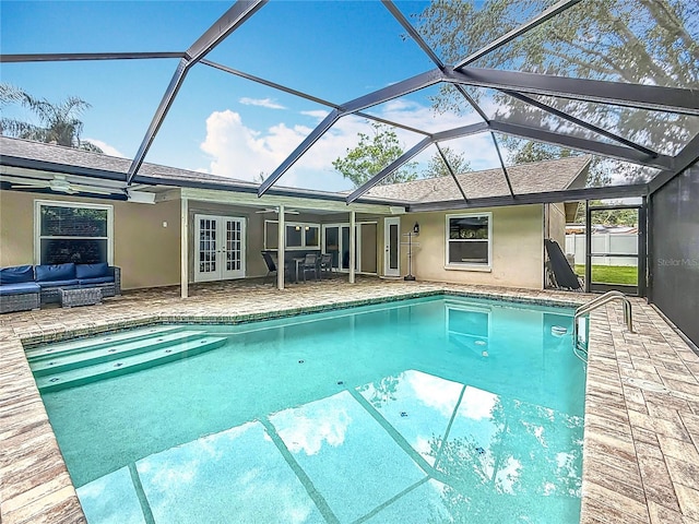 3093 Hillside Ln, Safety Harbor, FL 34695 - swimming pool featuring french doors, an outdoor hangout area, a patio area, ceiling fan, and glass enclosure