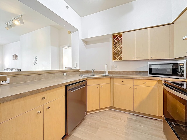 200 4th Ave S Unit 229, Saint Petersburg, FL 33701 - kitchen featuring appliances with stainless steel finishes, a sink, light brown cabinets, open shelves, and light wood-style flooring