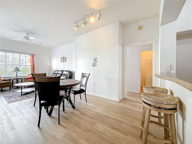 200 4th Ave S Unit 229, Saint Petersburg, FL 33701 - dining area with light wood-style floors, ceiling fan, rail lighting, and baseboards