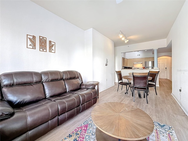 200 4th Ave S Unit 229, Saint Petersburg, FL 33701 - living room with ornate columns, arched walkways, and light wood-type flooring