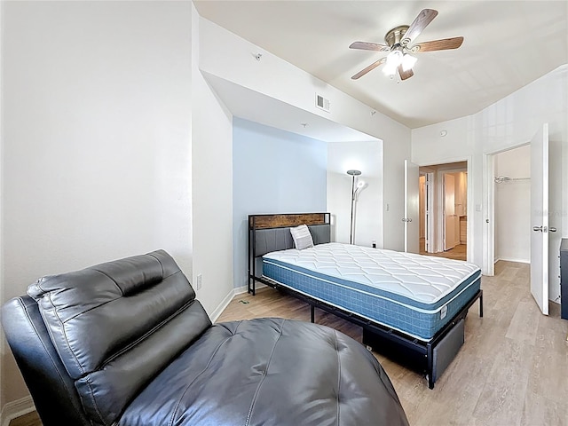 200 4th Ave S Unit 229, Saint Petersburg, FL 33701 - bedroom with light wood-style floors, vaulted ceiling, baseboards, a ceiling fan, and a spacious closet